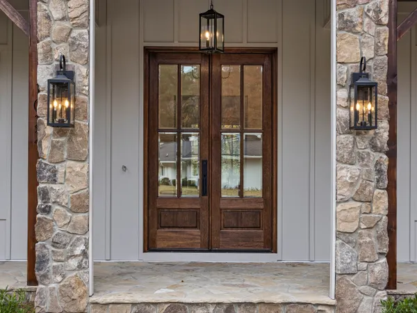 Puerta de entrada de madera con paños de vidrio